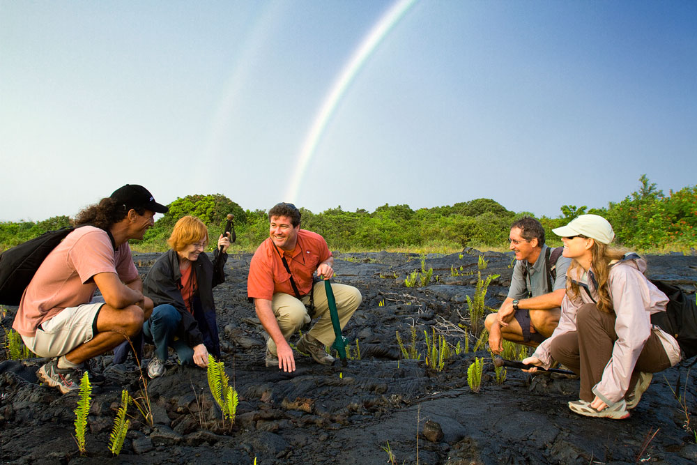 tour group examines lava rock